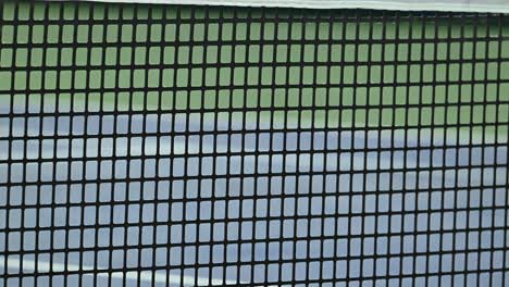 Close-up-of-a-professional-tennis-net-designed-for-ATP-tournaments,-made-with-durable-rubber-material