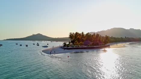 Low-orbit-drone-shot-of-sunset-Siwalai-beach-on-Koh-Mook-tropical-island-in-Andaman-sea-in-Trang,-southern-Thailand