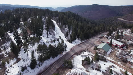 Aerial-drone-shot-of-road-in-to-Cloudcroft,-New-Mexico,-boom-up