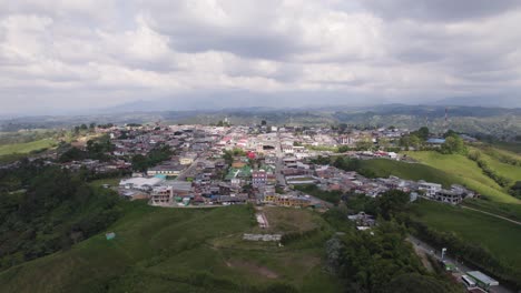 Luftaufnahme-Der-Stadt-Filandia-Auf-Einem-Hügel,-Umgeben-Von-Grünen-Feldern,-Gelegen-Auf-Der-Westseite-Der-Cordillera-Central-Der-Anden-Bergkette