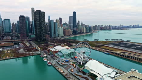 Aerial-view-passing-the-Centennial-Wheel-at-Navy-Pier,-in-rainy-winter-day-in-Chicago