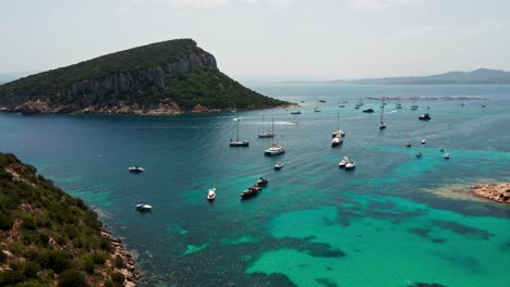 Savor-the-charm-of-Spiaggia-di-Cala-Moresca,-where-pristine-sands-meet-azure-waters-in-a-tranquil-coastal-oasis