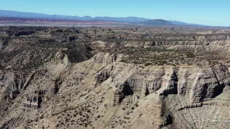 Flyover:-Steep-mesas-of-dry-eroded-sandstone-on-mountain-plateau