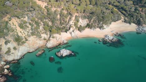 A-bird's-eye-view-reveals-Lloret-De-Mar's-azure-sea,-sandy-beaches,-and-luxurious-resorts,-attracting-high-end-tourists-to-Santa-Cristina-and-Cala-Treumal