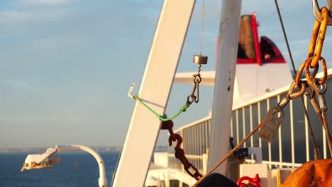 A-tight-shot-of-various-rigging,-chains,-and-structures-on-the-side-of-a-boat