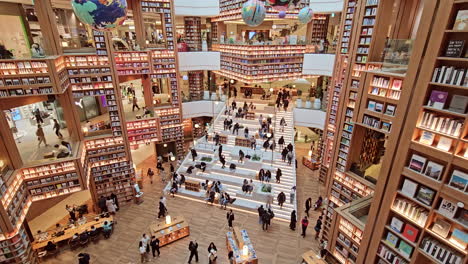 Starfield-Suwon-Library-Hall-Interior-With-Many-People-Shopping-And-Reading-Books---tilt-up