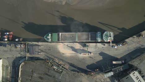 Top-Down-Aerial-View-Of-Container-Ship-Unloading-Shipment-From-Cargo-Depot