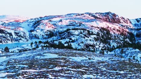 Snowy-Mountains-And-Fields-In-Bessaker,-Norway-During-Winter---Drone-Shot