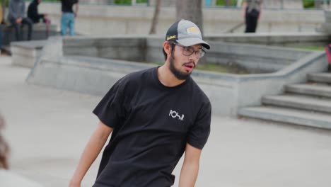 A-Young-Teenager-Man-Rides-his-skateboard-down-a-concrete-rail-at-a-skatepark