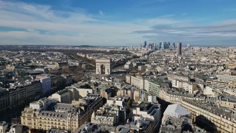 Triumphal-arch-or-Arc-de-Triomphe-with-Montparnasse-tower-and-La-Defense-skyscrapers-in-background,-Paris-urbanscape,-France
