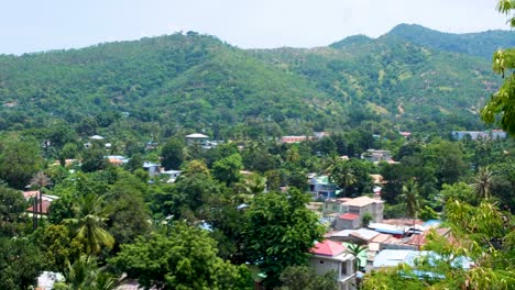 Scenic-landscape-view-of-local-community-houses-nestled-amongst-green-trees-and-hills-in-the-capital-city-of-Dili,-Timor-Leste,-Southeast-Asia
