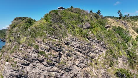 Drone-shot-climbing-the-cliffs-that-border-the-coast-that-connects-them-to-a-paradisiacal-beach-in-the-Caribbean