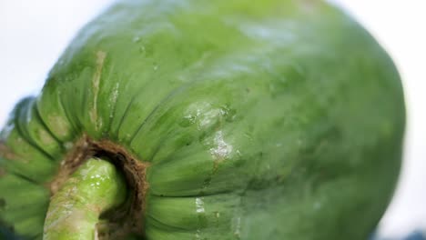 Extreme-close-up-Ripe-yellow-papaya-paw-paw-spinning-on-a-rotating-platform-displaying-it's-beautiful-and-unique-spots-and-skin