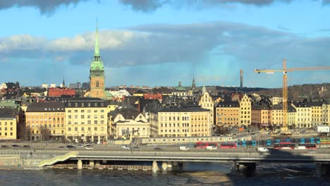 Wide-static-shot-of-car-and-train-traffic-by-Old-Town-in-Stockholm