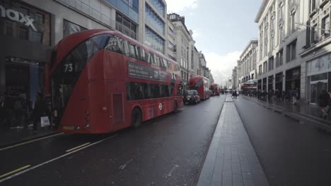 Row-of-double-decker-buses-and-cars-driving-in-Oxford-street