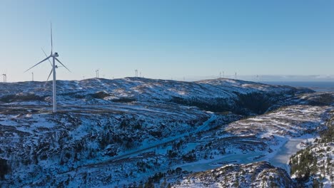 Windmills-Standing-Over-Snow-Mountains-Near-Bessaker,-Norway