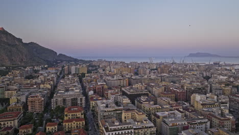 Palermo-Italy-Aerial-v4-cinematic-drone-flyover-Via-Principe-di-Paternò-street-capturing-charming-urban-cityscape,-marina-shipyard-and-Tyrrhenian-sea-at-sunset-dusk---Shot-with-Mavic-3-Cine---May-2023