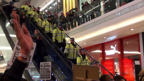 Dozens-of-Metropolitan-police-officers-descend-an-escalator-in-a-shopping-centre-during-a-Black-Lives-Matter-protest