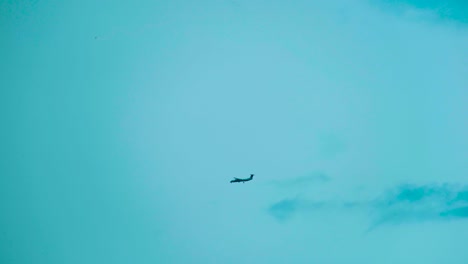 Silueta-De-Avión-Distante-Aterrizando-Sobre-Fondo-De-Cielo-Azul-Con-Espacio-De-Copia