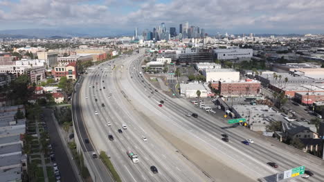 Pasadena-110-Freeway-in-city-of-Los-Angeles-on-a-cloudy-day,-aerial-of-downtown-LA