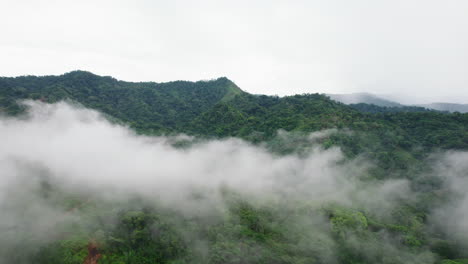 Aerial-hazy-view-of-wooded-hills-in-tropical-landscape