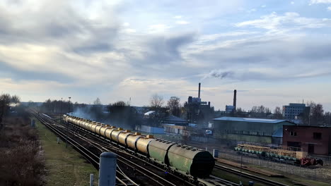 Slow-moving-train-passing-through-a-polluted-train-town