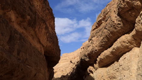Golden-sunlight-illuminating-the-rugged-textures-of-Mides-Canyon,-Tunisia,-under-a-clear-blue-sky