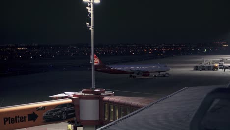 Airplane-of-airline-Air-Berlin-being-pushed-back-at-night-on-runway-at-german-now-closed-Berlin-airport-Tegel