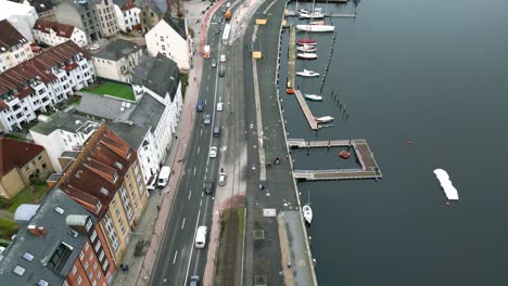 Drone-Flight-over-the-streets,-next-to-the-harbour-of-the-historic-city-in-Flensburg,-Germany