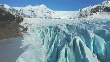 The-4K-drone-captures-distinctive-aerial-cinematic-shots-of-blueish-glaciers-within-Iceland-National-Park,-their-jagged-forms-resembling-sharp-ice-blades