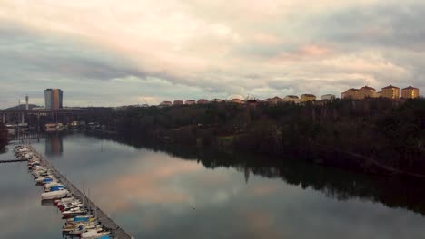 Forward-aerial-of-boats-in-marina-and-river-Arstaviken-in-Stockholm