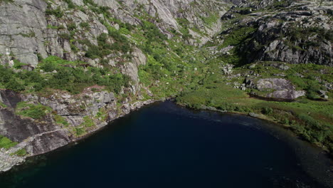 Aerial-shot,-starts-over-a-small,-shallow-lake-in-Norway