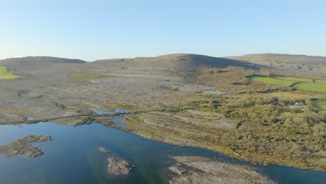 Panoramic-aerial-dolly-establishes-geologic-limestone-rock-formations-of-the-burren-Ireland-on-sunny-day