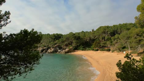 Delight-in-Lloret-De-Mar's-aerial-panoramas,-revealing-its-pristine-beaches-and-upscale-tourist-attractions-such-as-Santa-Cristina-and-Cala-Treumal