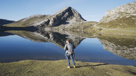 world-traveller-backpacker-walking-hiking-in-scenic-mountains-landscape-in-Asturias,-Covadonga-Enol-Spain