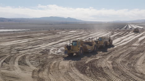 Large-industrial-vehicle-in-a-sandy-environment,-under-the-harsh-midday-sun