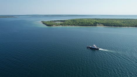 Drone-flight-over-a-ferry-transporting-many-cars-in-lake-Michigan