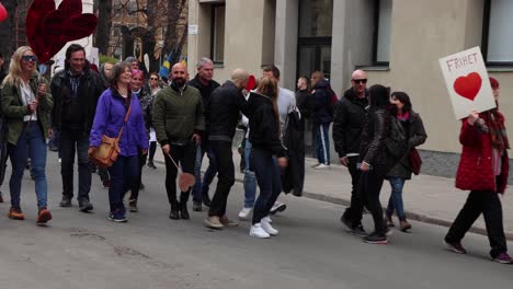 Covid-regulation-protesters-march-peacefully-in-Stockholm,-close-view