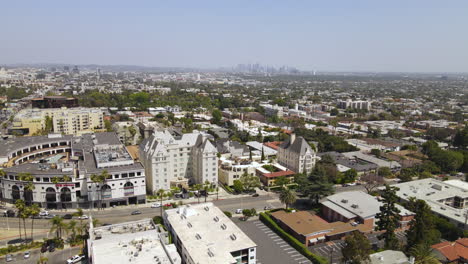 Aerial-view-of-West-Hollywood-cityscape,-Los-Angeles-California-USA,-buildings-and-boulevards-on-sunny-day