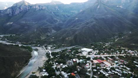 Aerial-panoramic-drone-tops-Urique-Copper-Canyon-Mexican-Mountain-Village-valley-at-sierra-madre-occidental,-Chihuahua,-green-valley-in-indigenous-mountain-tops,-Mexico