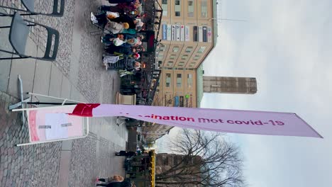 Banner-sign-at-outdoor-covid-vaccination-station-in-Sweden,-vertical