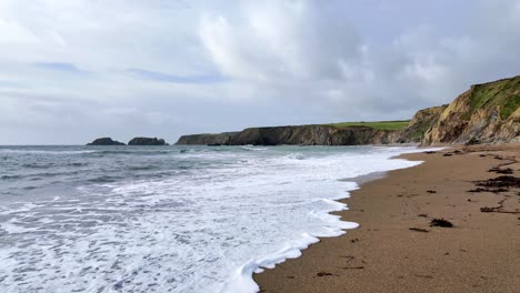 incoming-tides-and-waves-breaking-on-sandy-secluded-beaches-Waterford-Ireland-on-a-spring-morning