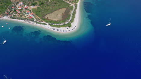 Aerial:-Backwards-reveal-shot-of-Agios-Dimitrios-amazing-sandy-and-crystal-clear-beach-in-Alonnisos-island,-Greece