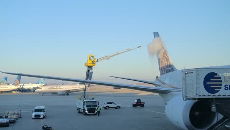Slow-Motion-Shot-of-De-Icing-Fluid-Being-Applied-to-Airplane-Rudder