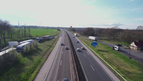 Aerial-View-of-Highway-Traffic-Between-Hungary-and-Austria-on-Sunny-Spring-Day,-Drone-Shot
