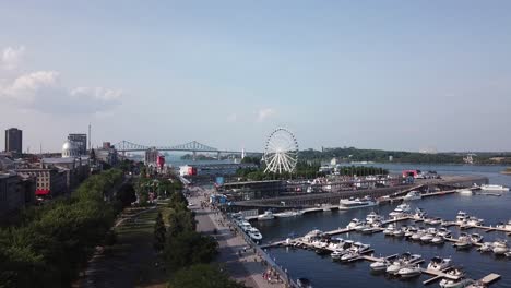 Drone-approaching-old-city-port-in-Montreal-Quebec-Canada-aerial-footage-of-metropolitan-cityscape