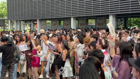 Scene-of-a-group-of-'Swifties'-happily-sing-and-dance-along-outside-the-National-Stadium-in-Singapore-for-Taylor-Swift,-The-Eras-Concert-Tour