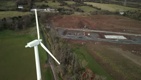 Aerial-shot-of-a-turbine,-moving-left-to-right-behind-the-turbine