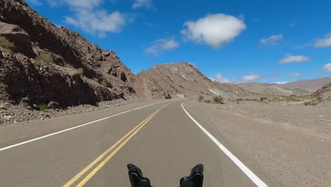 Motorcycle-POV:-View-from-moto-riding-highway-through-rugged-mountains