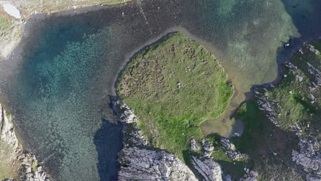 Cascata-di-stroppia-and-lago-niera-surrounded-by-lush-nature,-aerial-view